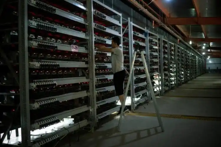 High-tech mining farm with rows of Bitcoin mining machines in secure environment
